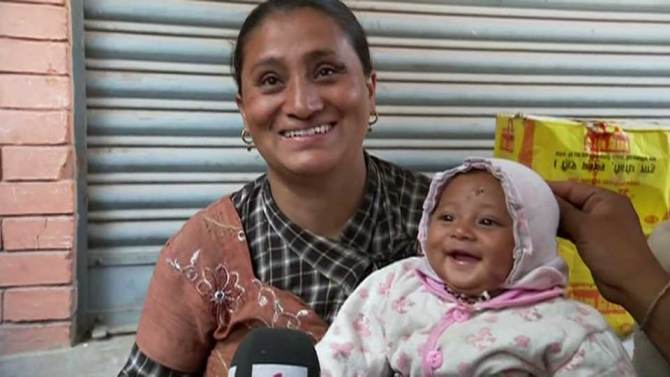 Smiles from a mother and her 4 month old baby who was rescued from days in the rubble.